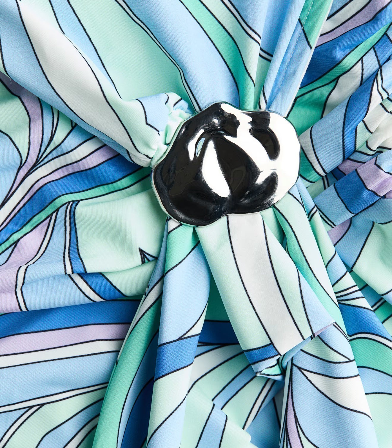 Miraee Paris Signature Maxi Dress featuring a blue, green, and lavender abstract print with a metallic silver brooch.