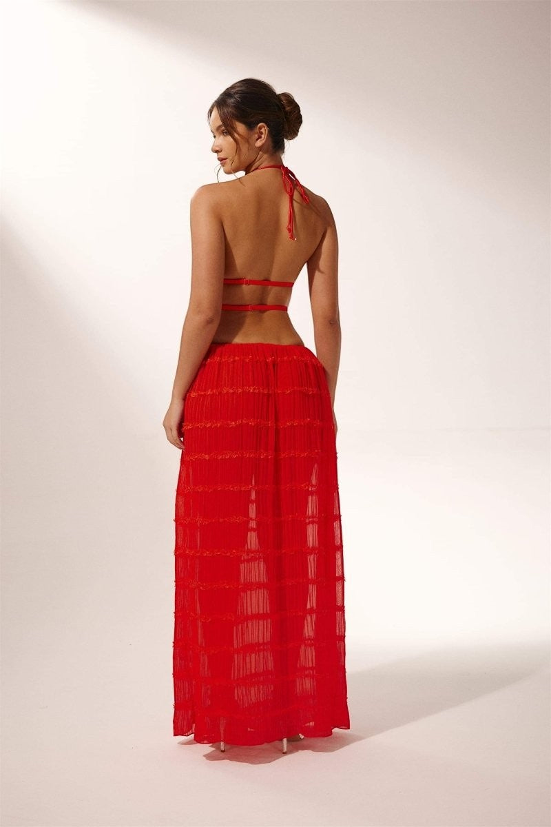 Miraee Paris red two-piece set with a backless halter top and a pleated maxi skirt in sheer chiffon fabric.